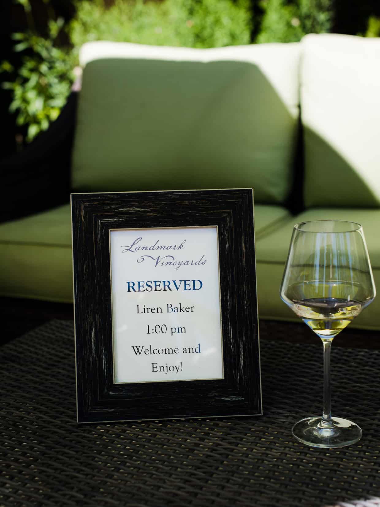 A small photo frame marking a reserved table at a wine tasting.