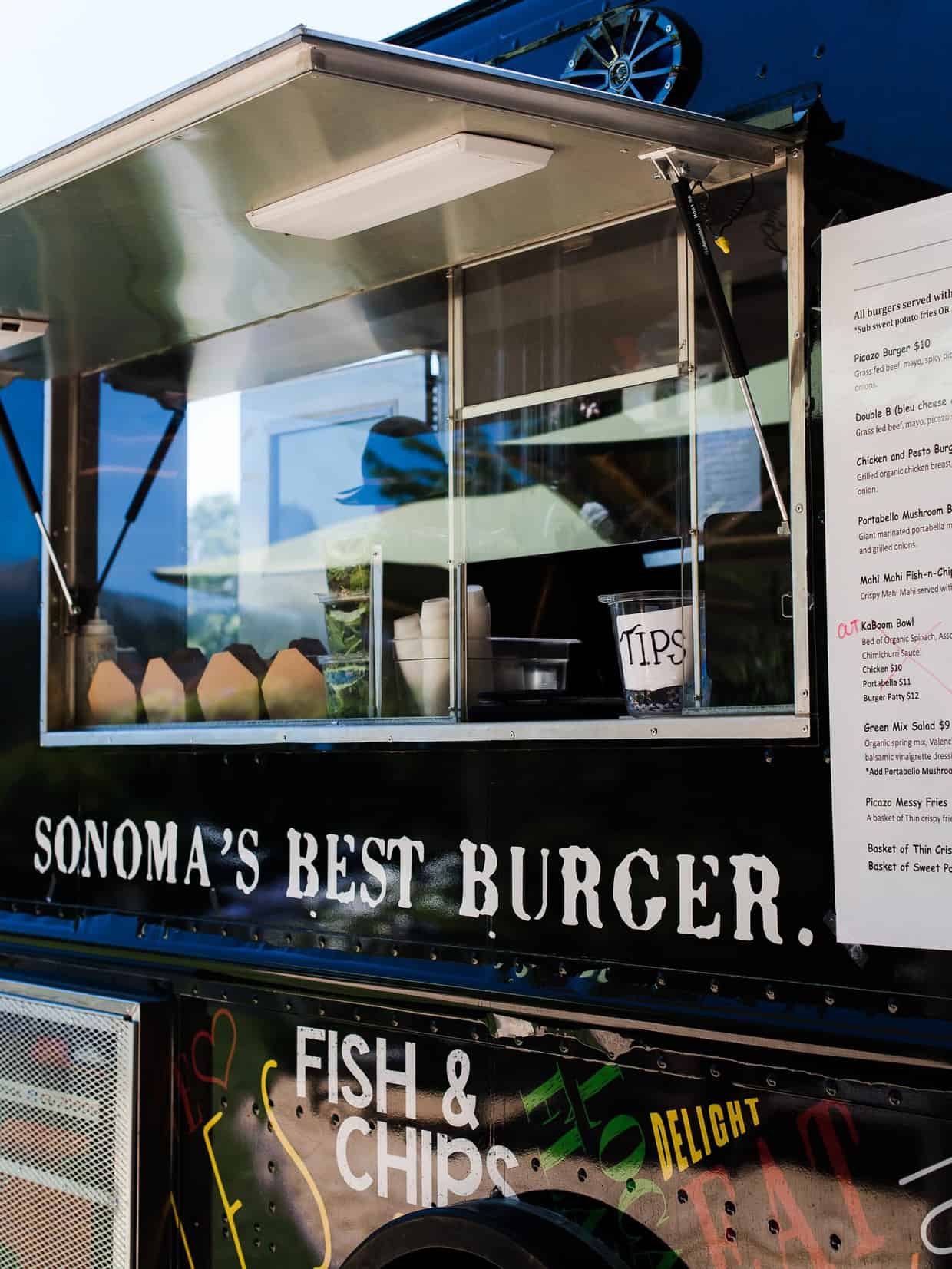 The order window of a food truck selling hamburgers.