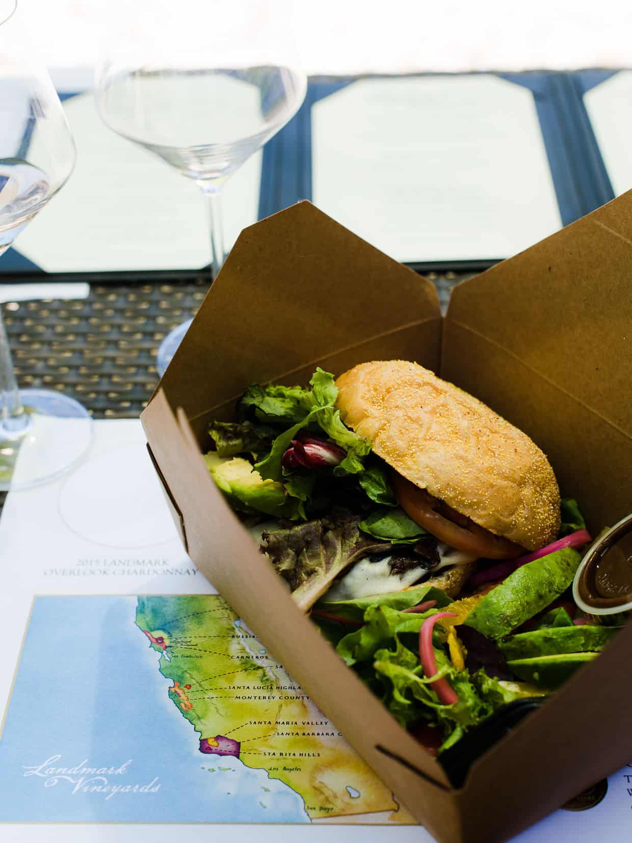 A portobello mushroom burger in a cardboard takeout box.