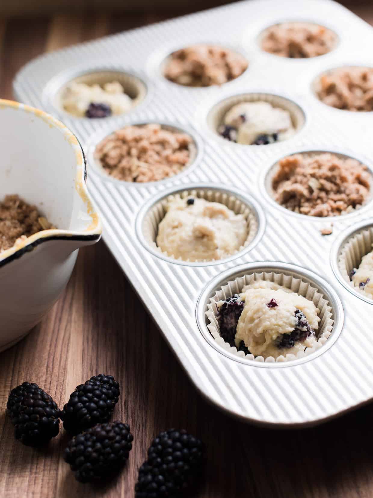 Muffin tin filled with Blackberry Yogurt Muffins ready to be baked.