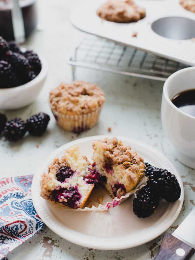 blackberry yogurt muffins cut in half on plate
