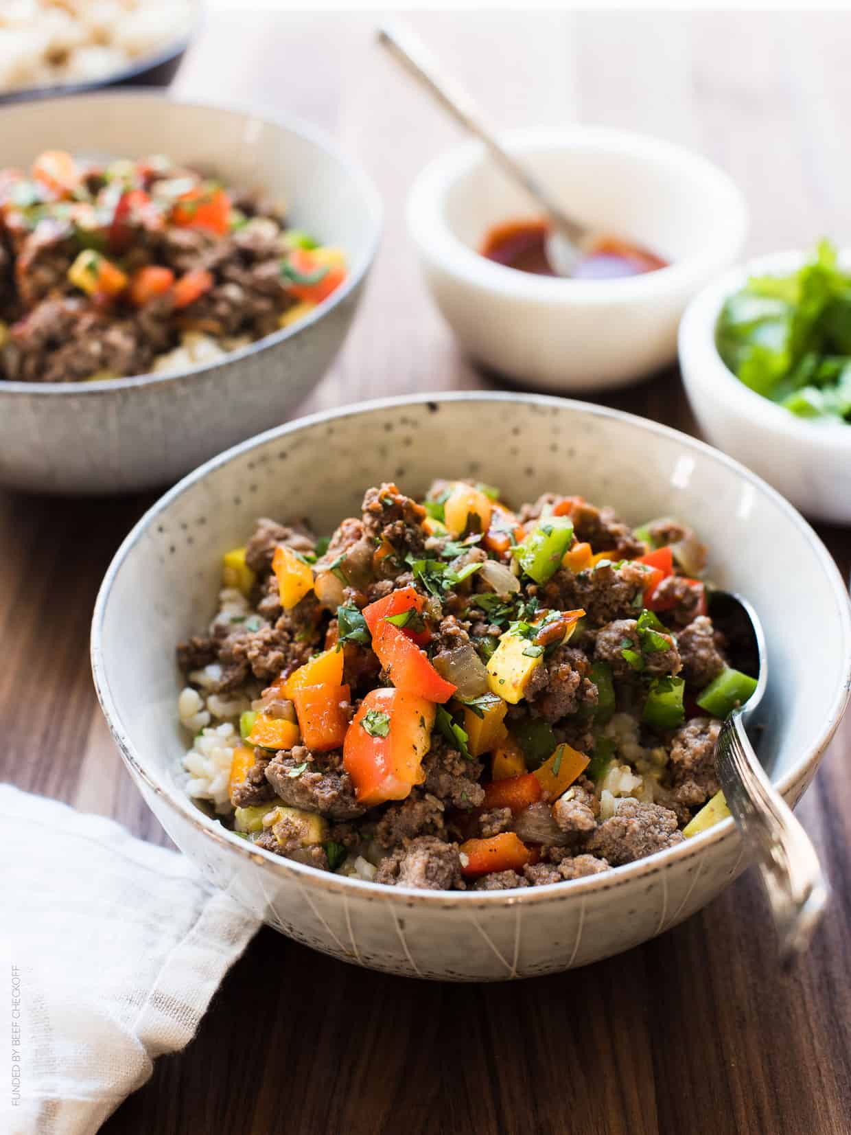 Bowl of Filipino-style Picadillo served on a wooden dining table.