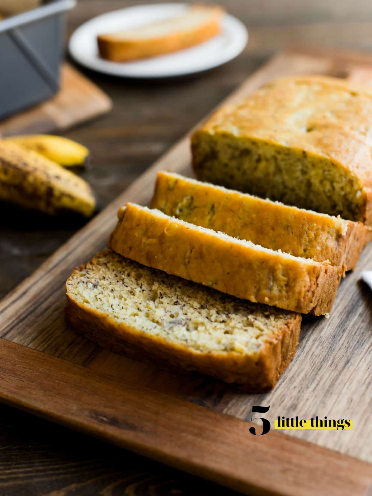 Banana bread sliced on a cutting board.