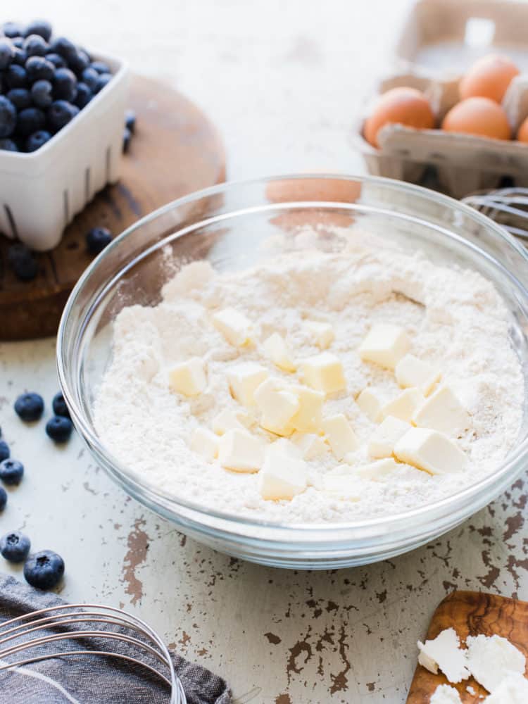 Ingredients for scones being creamed together in a glass bowl.