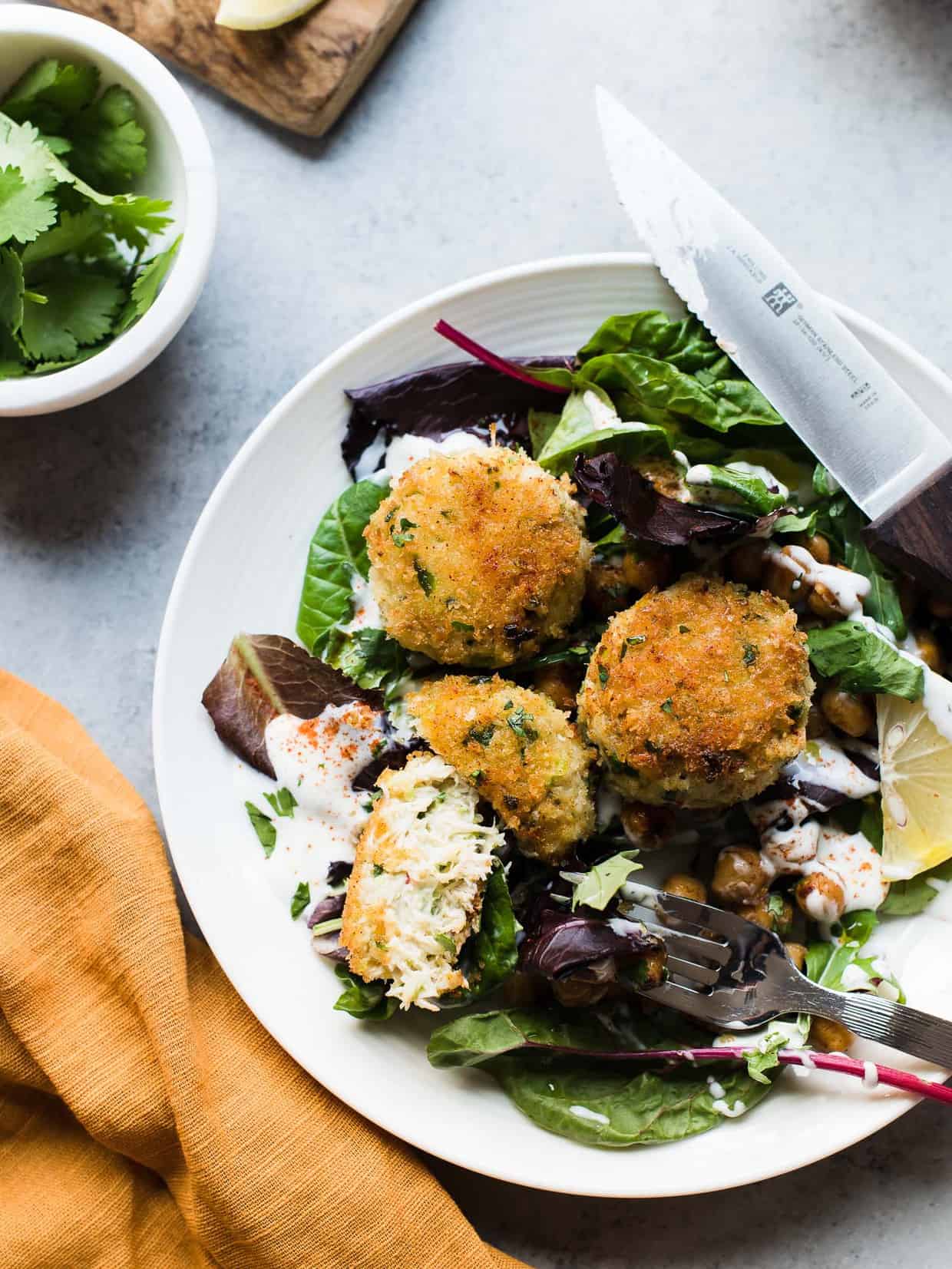 Chickpea Crab Cakes served a top of fresh greens.