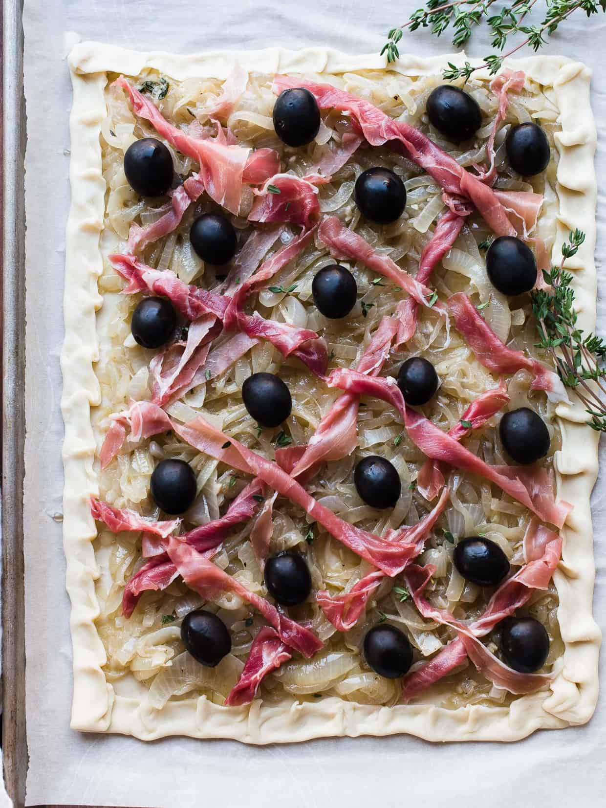 Pissaladière with Prosciutto ready to go into the oven.