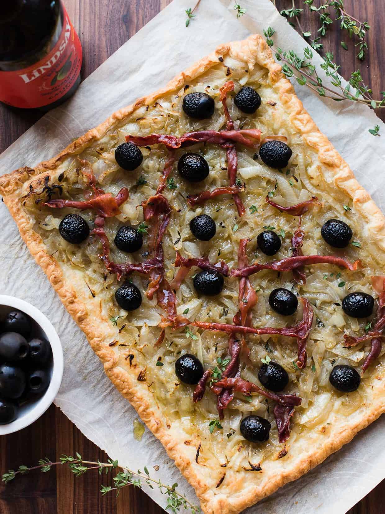 Ribbons of prosciutto on a freshly baked pissaladière.