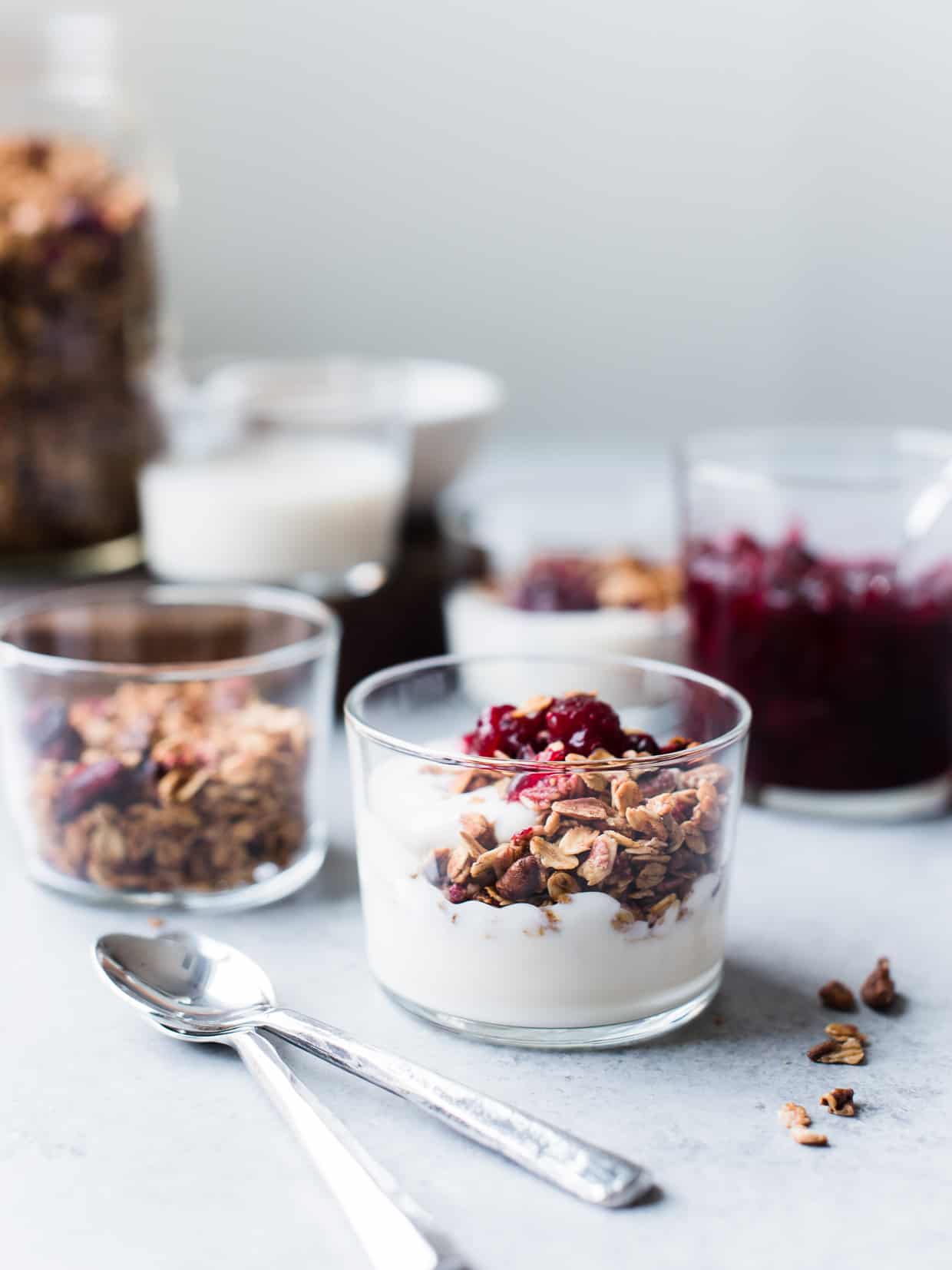 Cranberry Sauce Granola served in glasses with yogurt.