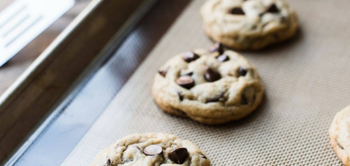 Cream Cheese Chocolate Chip Cookies fresh out of the oven on a baking tray.