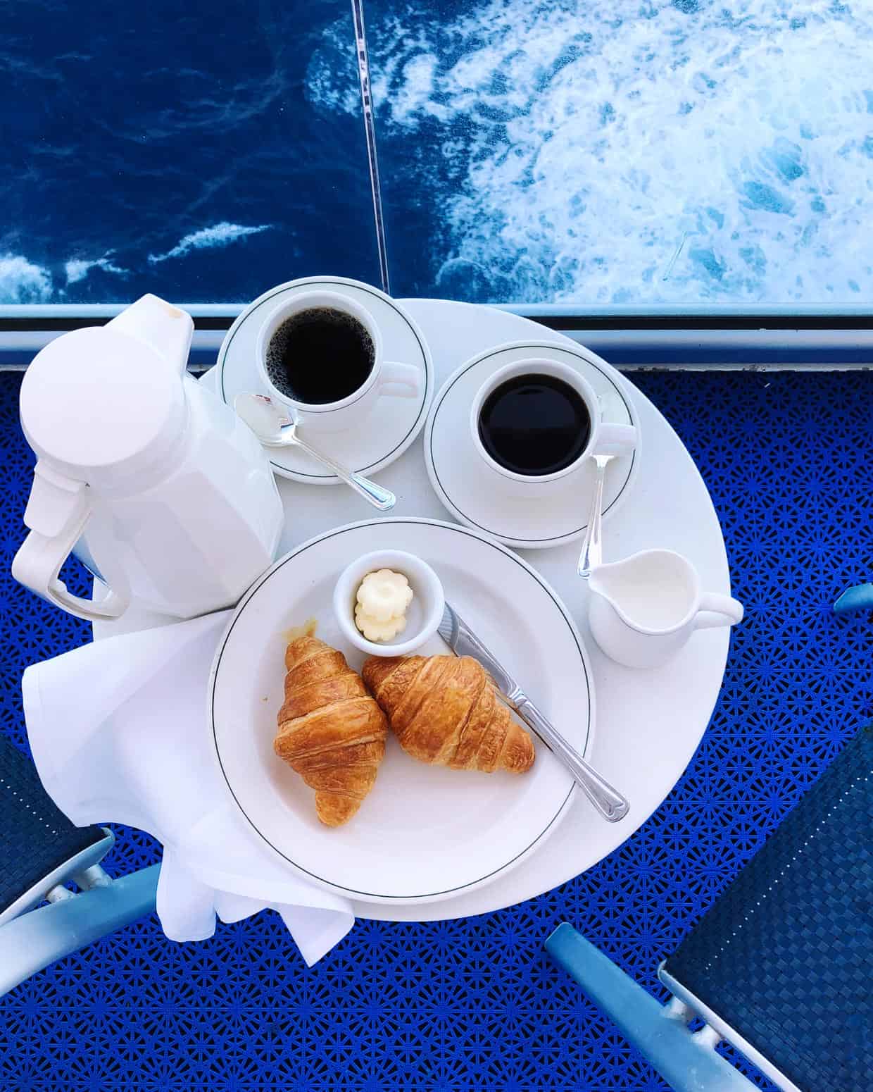 Croissants served on a white plate for breakfast on the balcony on the Ruby Princess.