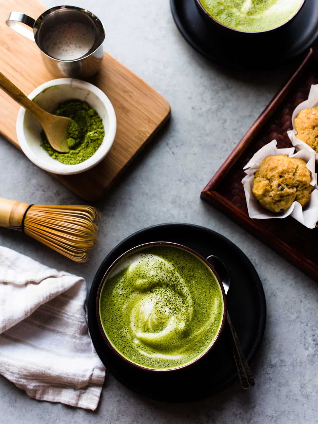 Freshly homemade matcha green tea latte with lots of foam floating on top.