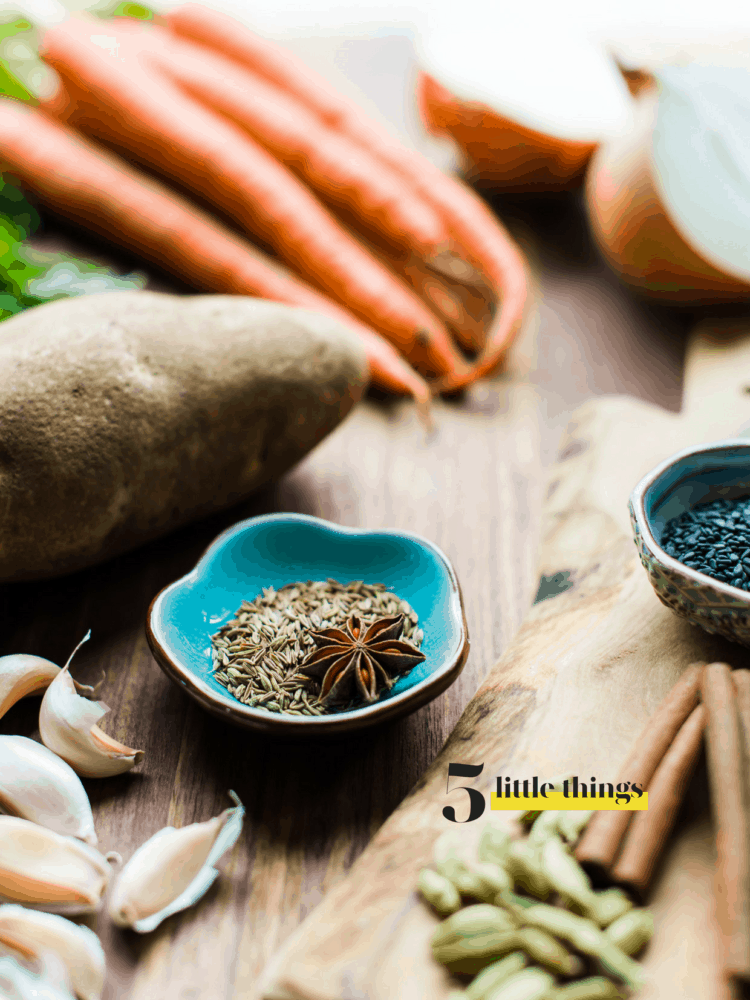 star anise, cumin and spices on a cutting board.