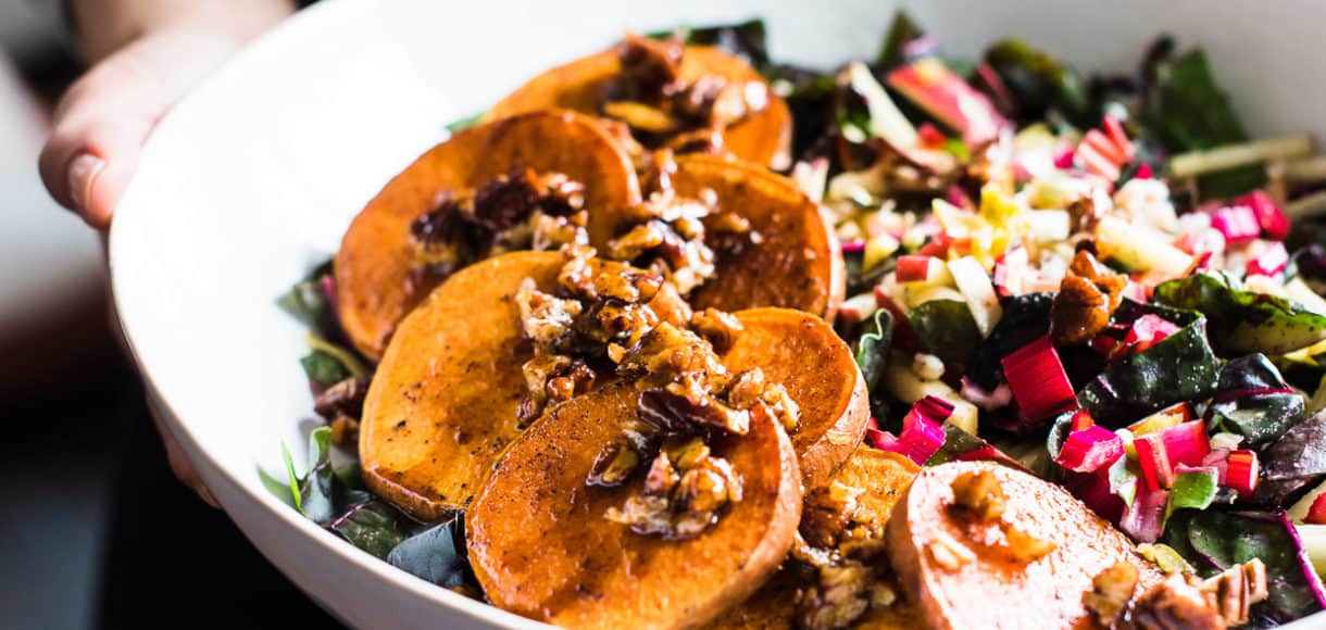 woman holding white bowl of Winter Farro Salad from Green Chef