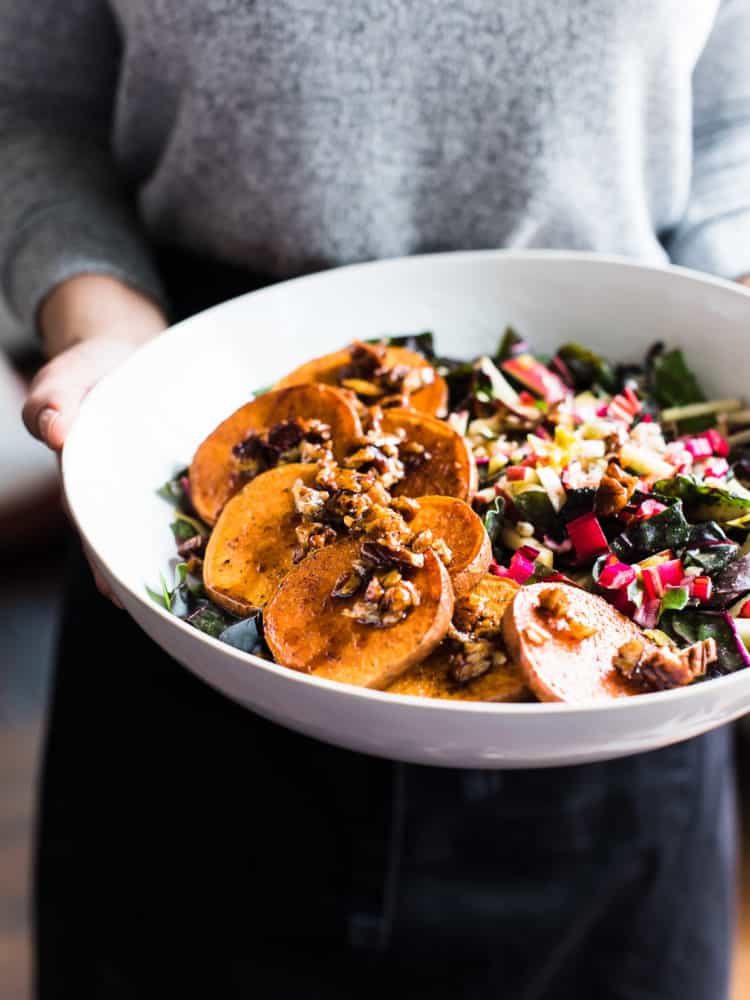 woman holding white bowl of Winter Farro Salad from Green Chef