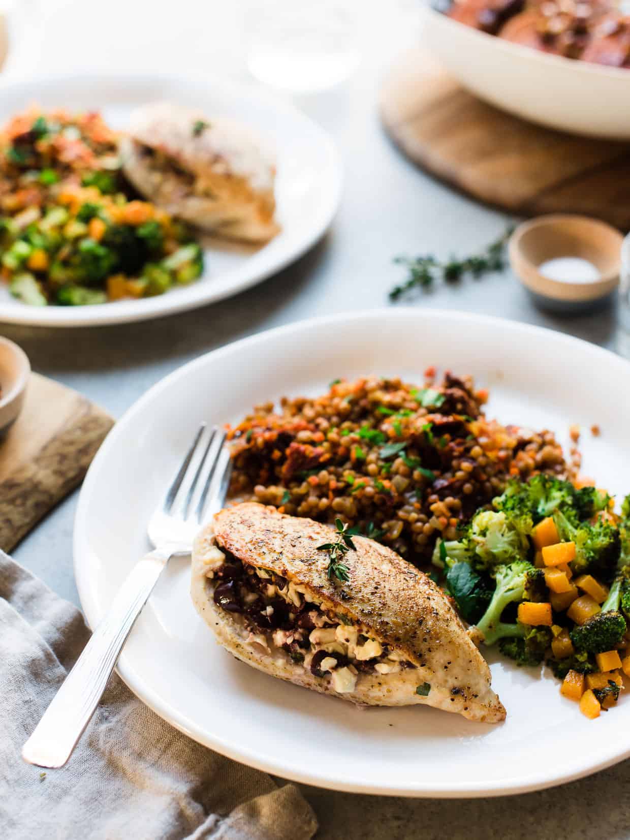  Feta-Stuffed Chicken, roasted broccoli and butternut squash and couscous on a white plate 