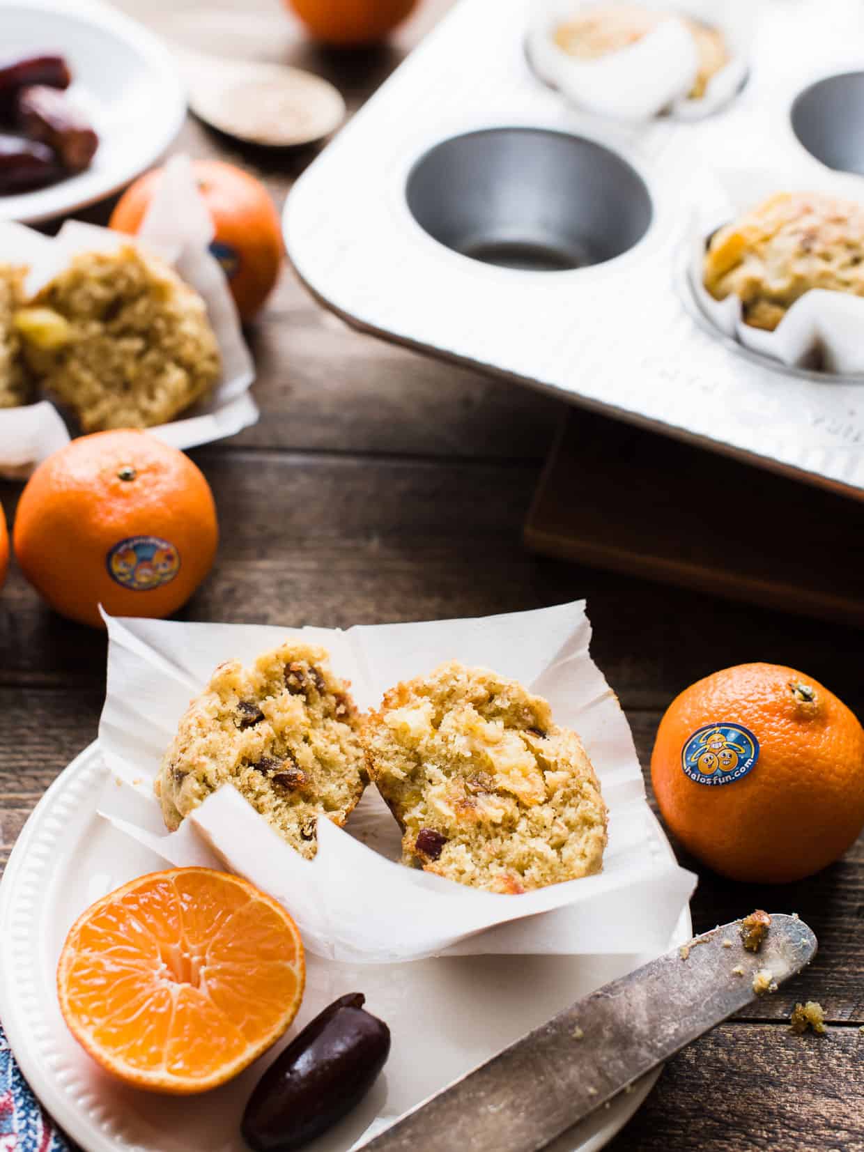 A sliced Mandarin Orange Ginger Date Muffin on a plate made with Wonderful Halos.