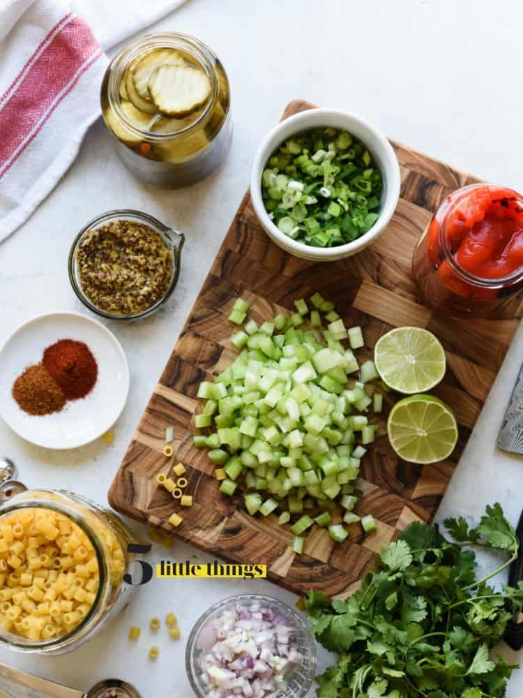 Cutting board with sliced celery, lime and spices.