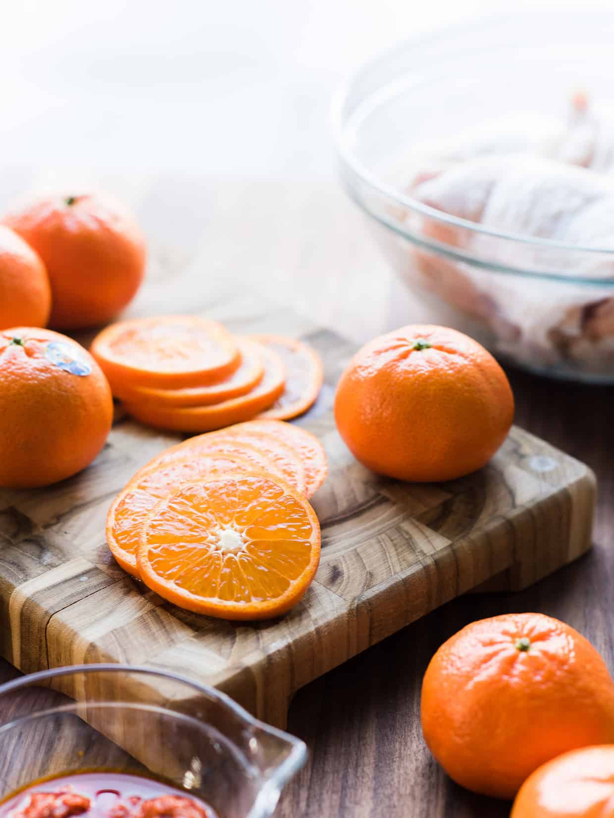 Slices of mandarin oranges on a cutting board.