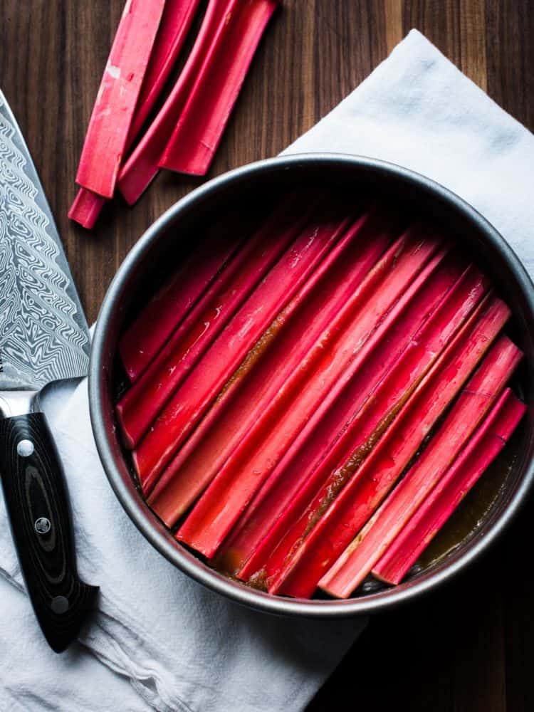 Slices of rhubarb in cake pan for Rhubarb Upside-Down Cake