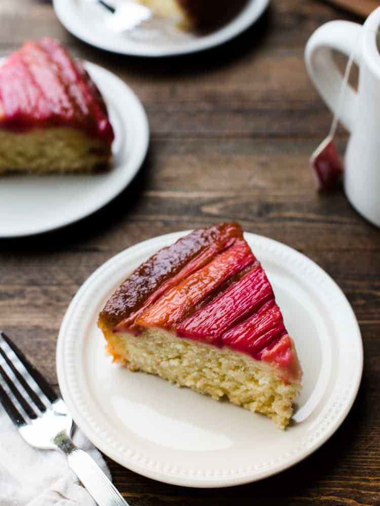 Slices of Rhubarb Upside-Down Cake on brown table.