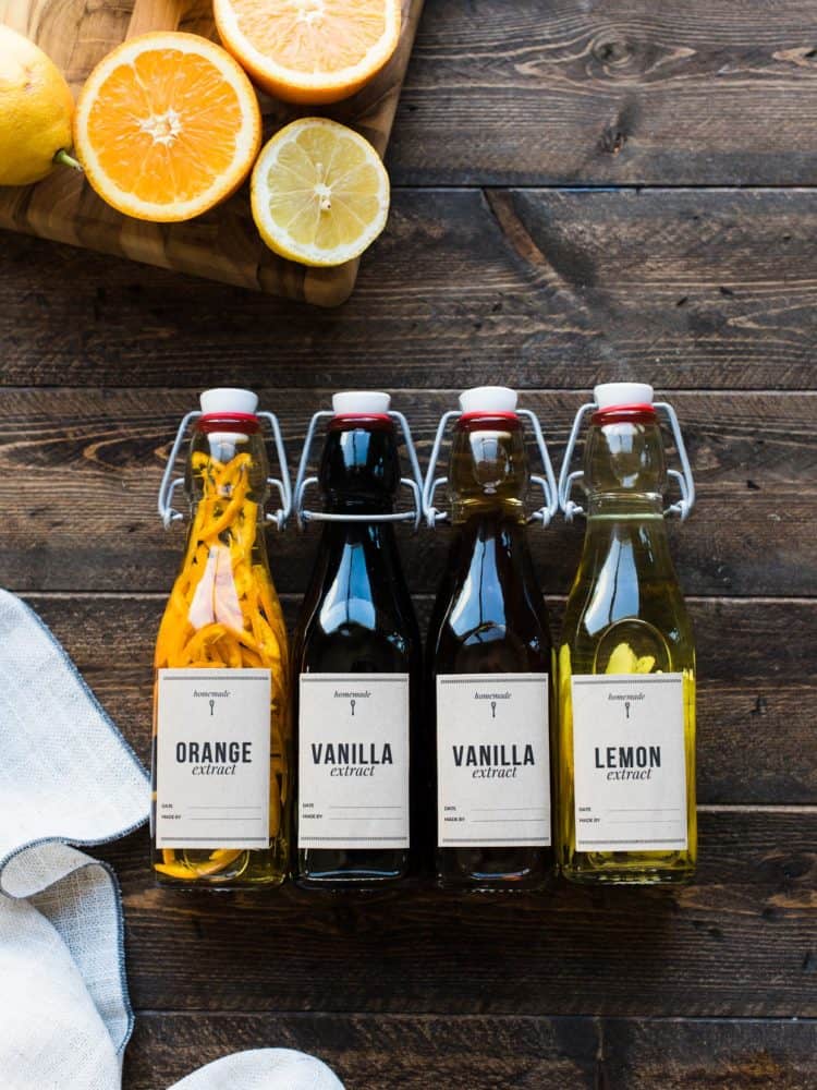 Homemade vanilla, orange and lemon extracts in bottles.