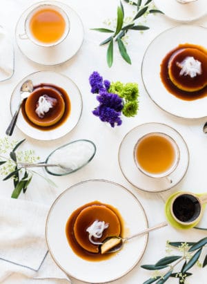 Coconut Leche Flan on white plates on a white table served with tea.