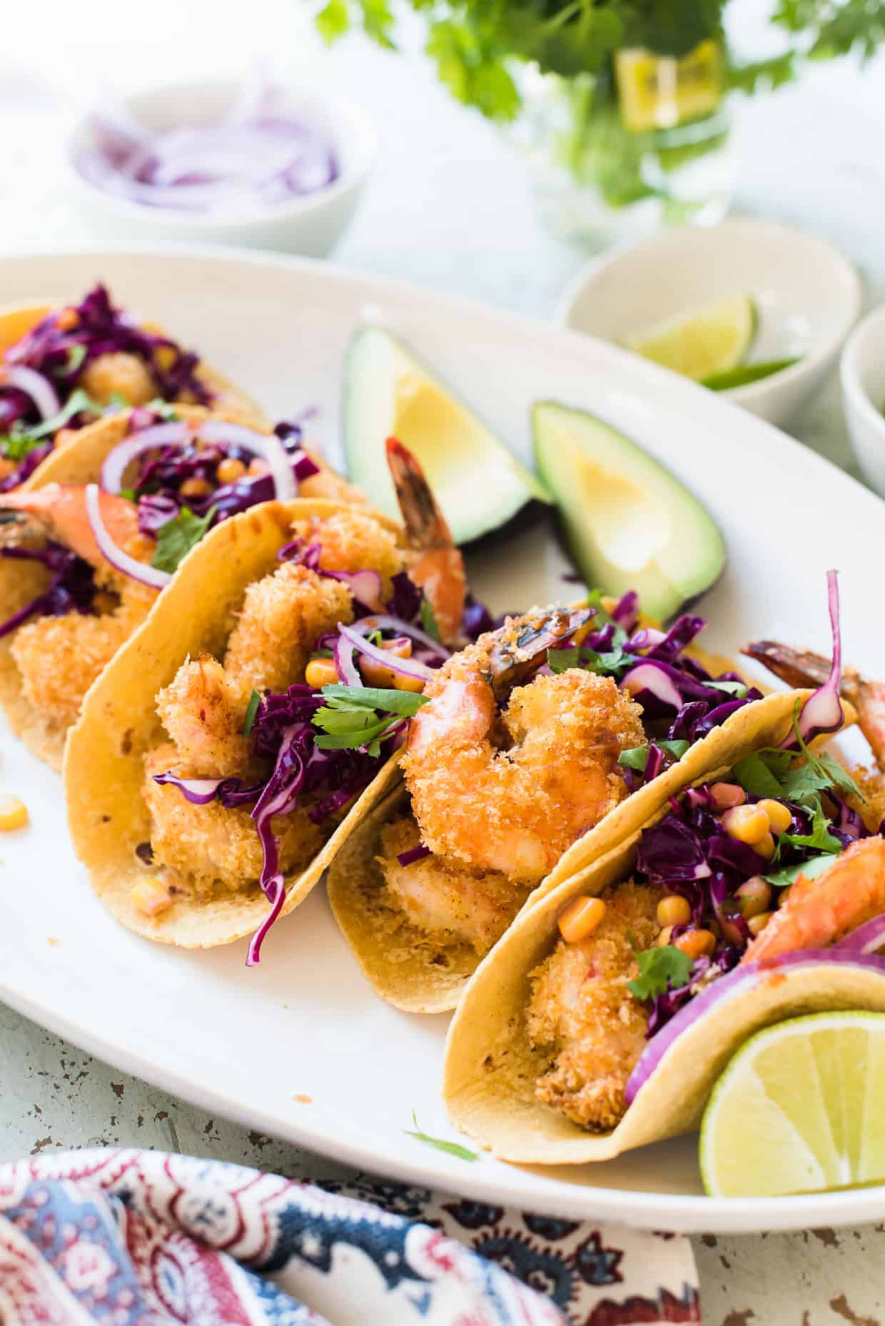 Tacos with oven-fried crispy shrimp, red cabbage and corn