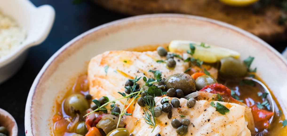 Instant Pot Fish Stew with Tomatoes, Olives and Capers in a cream bowl.