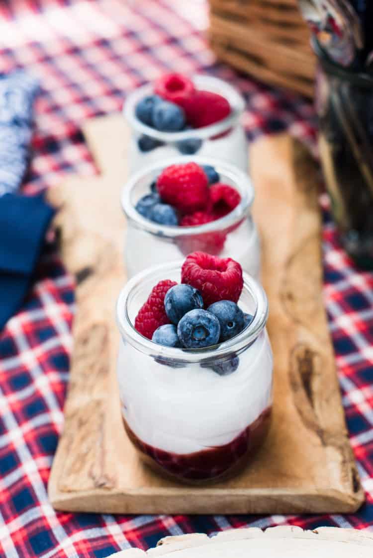 Mixed Berry Fruit-on-the-Bottom Yogurt Cups on a cutting board.
