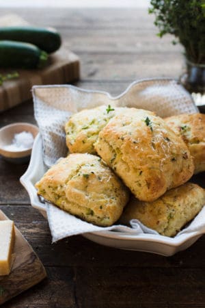 Savory Zucchini Scones with Feta and Thyme in a serving platter on a wood table.