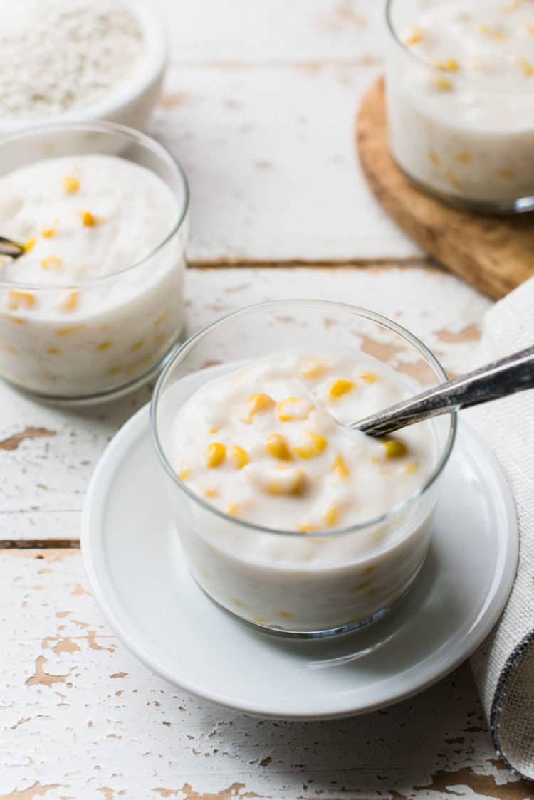 Glass of Ginataang Mais, a creamy sticky rice and corn pudding in coconut milk