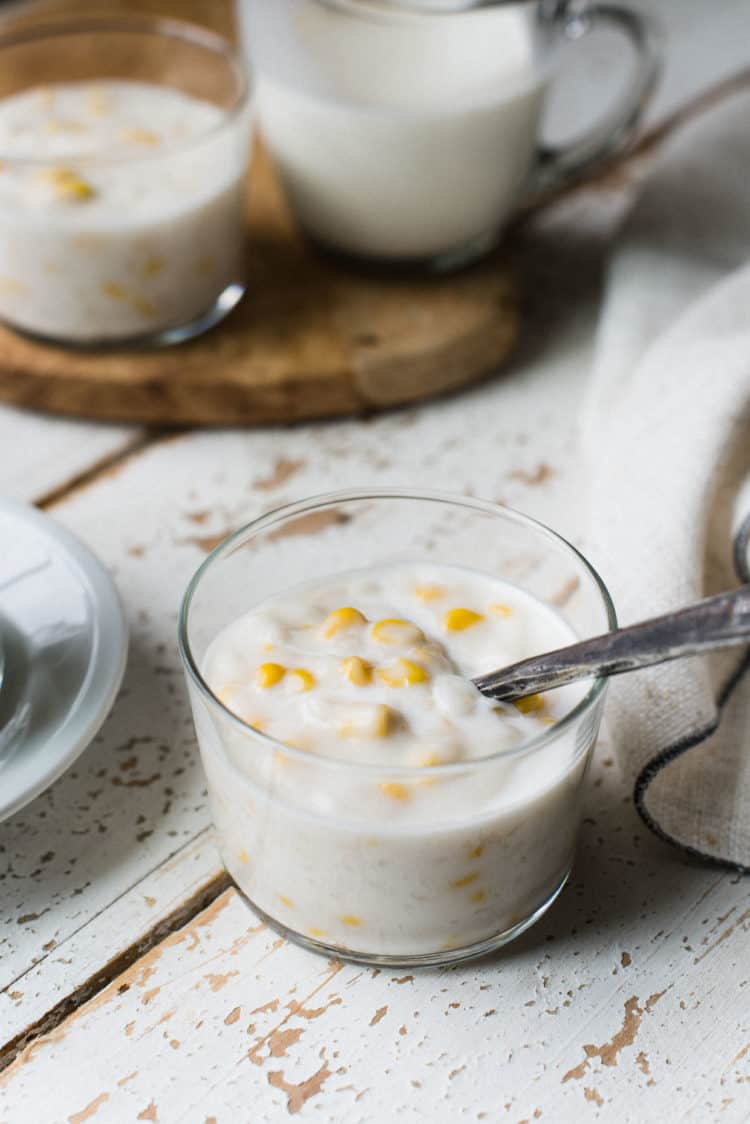 Filipino Coconut Rice Pudding with Corn served in a small glass.