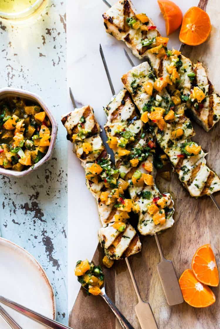 Grilled Swordfish Kebabs with Citrus Herb Salsa on a cutting board with salsa on the side.