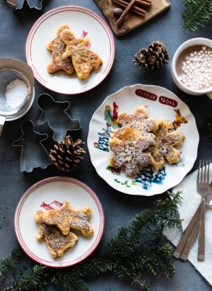 Holiday plates with gingerbread french toast dusted in powdered sugar.