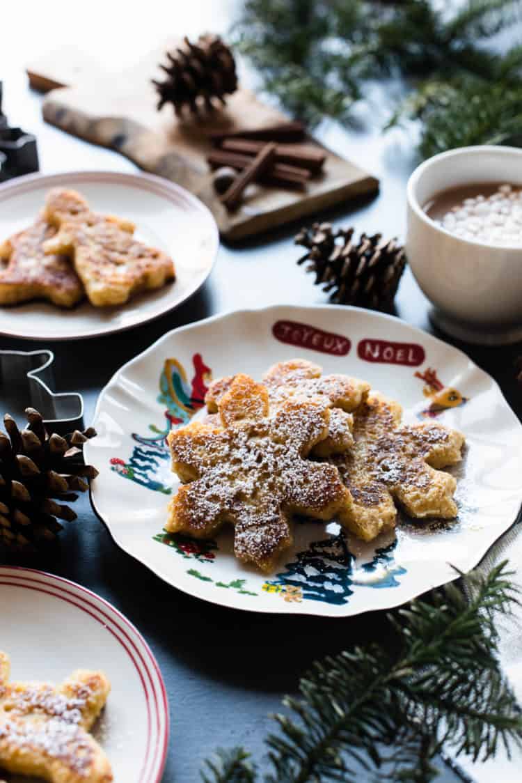 Gingerbread French Toast shaped like snowflakes on a holiday plate.