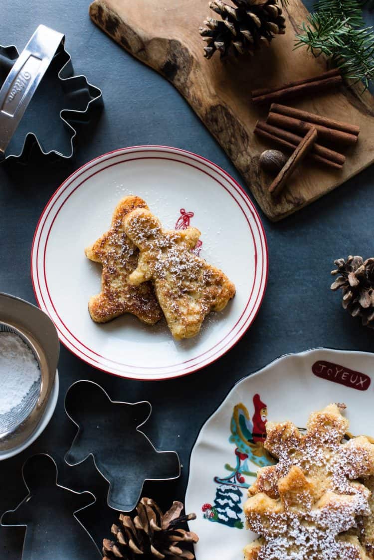Gingerbread French Toast shaped like gingerbread men on a holiday plate.