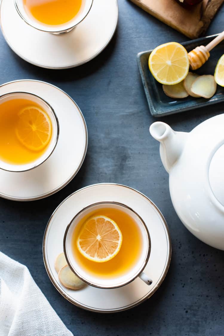 Cups of Homemade Fresh Ginger Tea with slices of lemon.