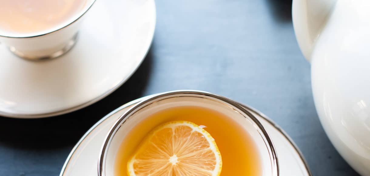 Homemade Fresh Ginger Tea with a slice of lemon in tea cups.