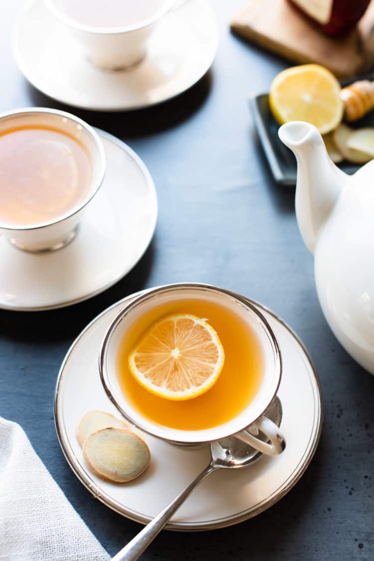 Homemade Fresh Ginger Tea with a slice of lemon in tea cups.
