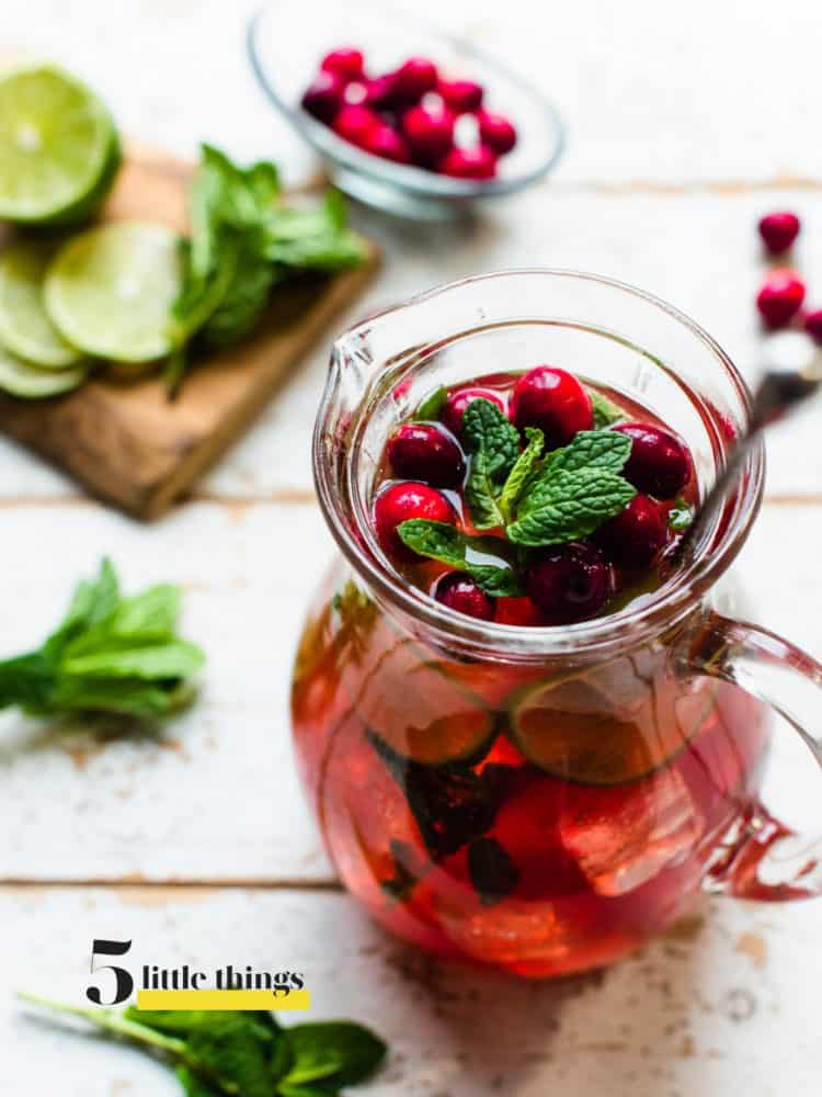 A cranberry pomegranate mojito in a pitcher.