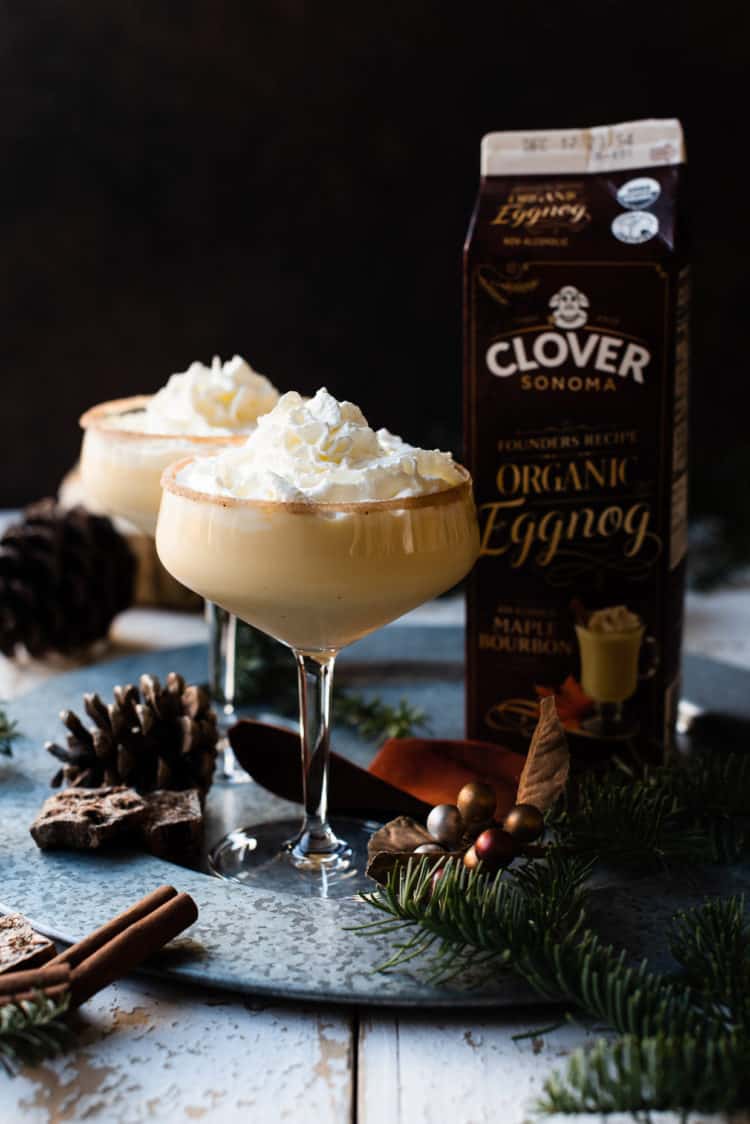 Glasses of Maple Bourbon Eggnog from Clover Sonoma with whipped cream.