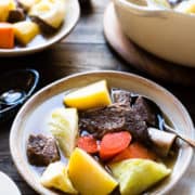 A bowl of Beef Nilaga (Filipino Beef and Vegetable Soup) made in the Instant Pot. Chunks of beef, short ribs, potato, cabbage, carrots, and sweet potato in a bowl.
