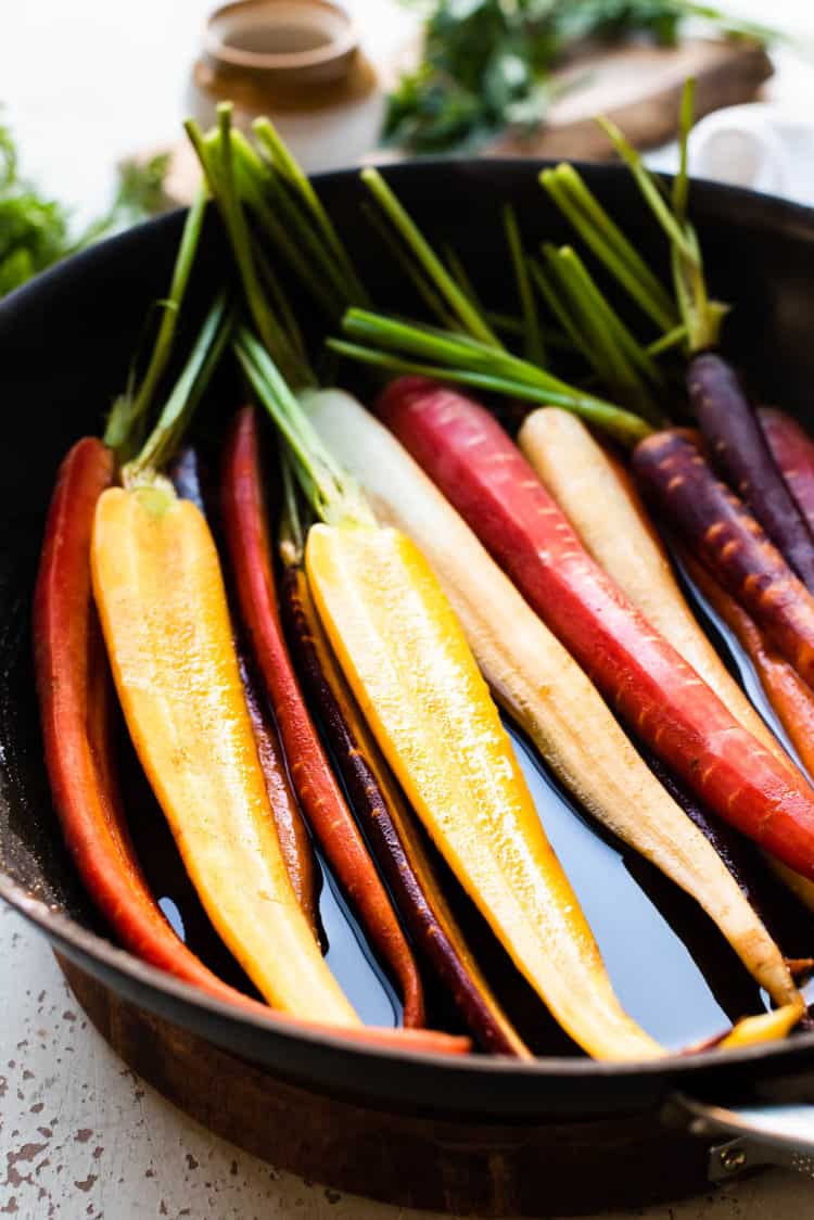 Carrots in pan with honey glaze for Honey-Spice Glazed Carrots.