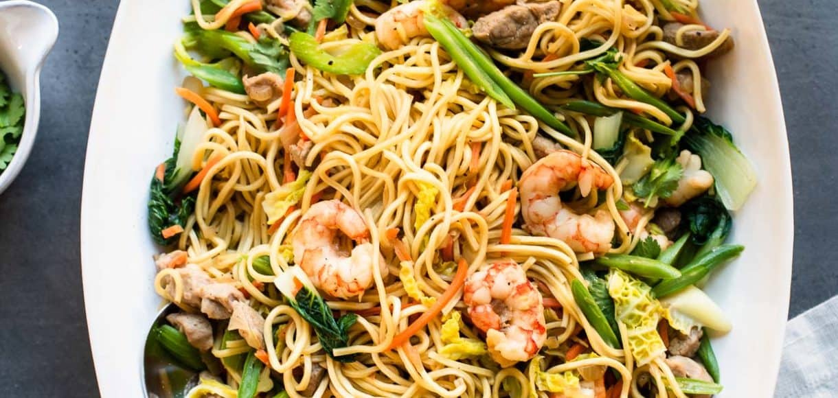 Pancit Canton: Filipino Stir-Fry Noodles with shrimp and vegetables in a white serving platter.