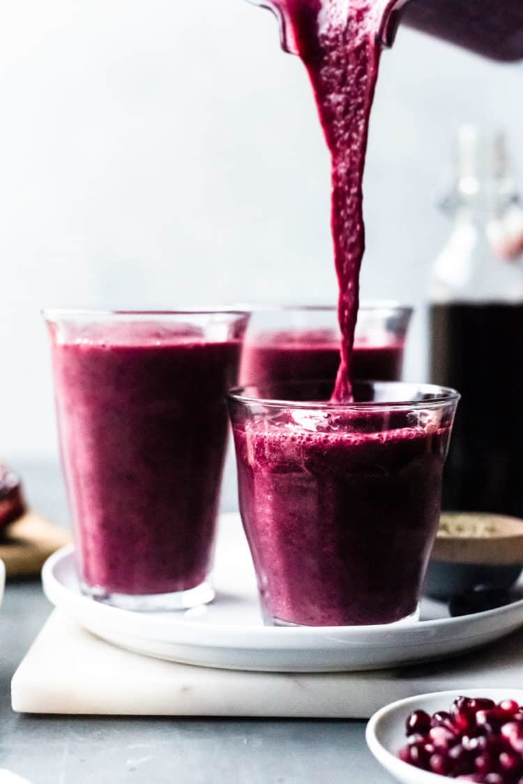 Pouring Pomegranate Berry Smoothie into glasses.