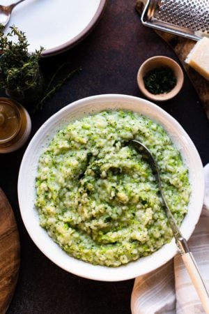 Broccoli Risotto in a white serving bowl garnished with parsley.