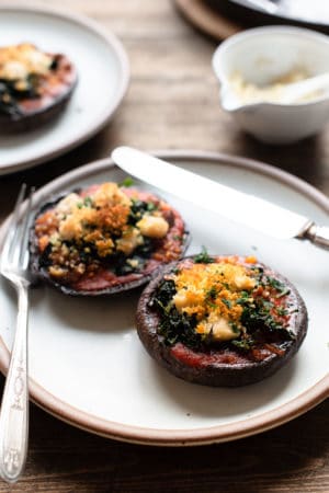 Stuffed Portobello Mushrooms with Garlicky Kale on a plate.