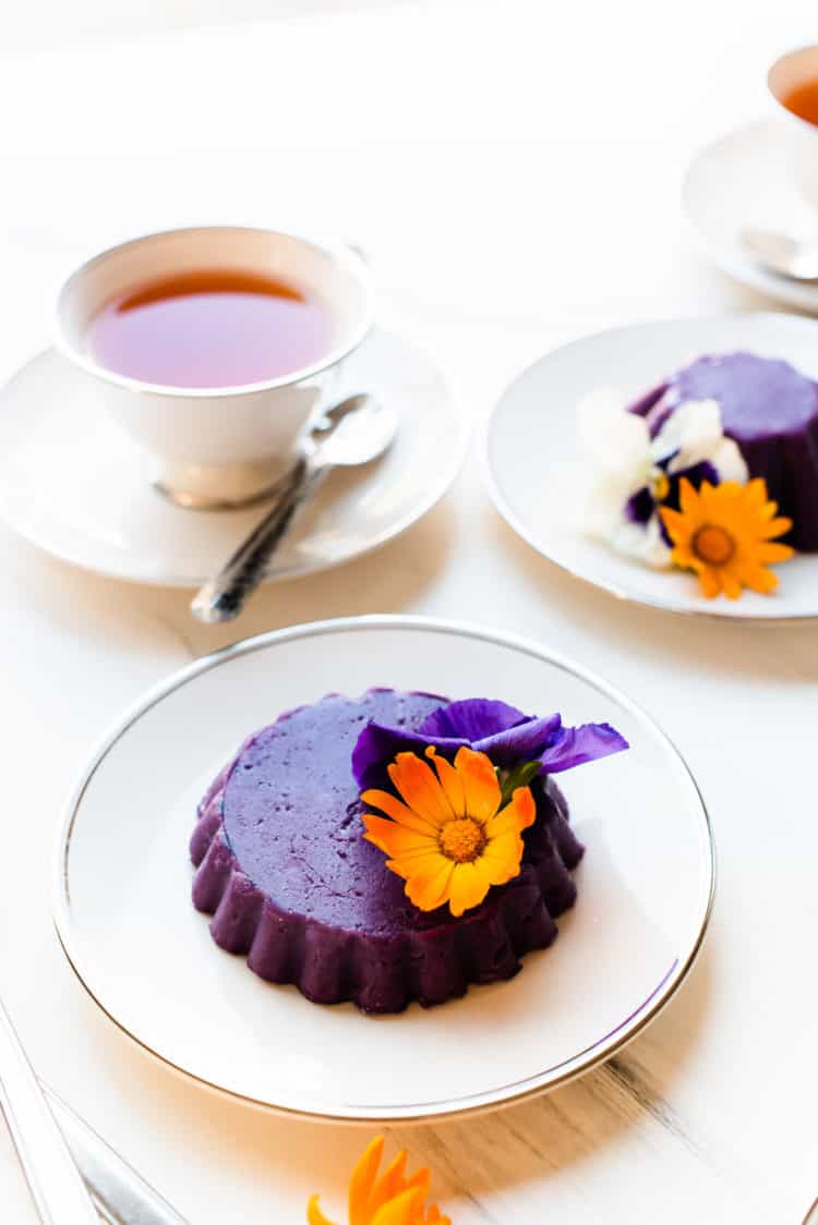 Ube Halaya molded into a pretty cake and garnished with edible flowers.