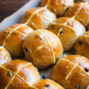 Glazed hot cross buns on a baking sheet. Overnight vegan recipe.