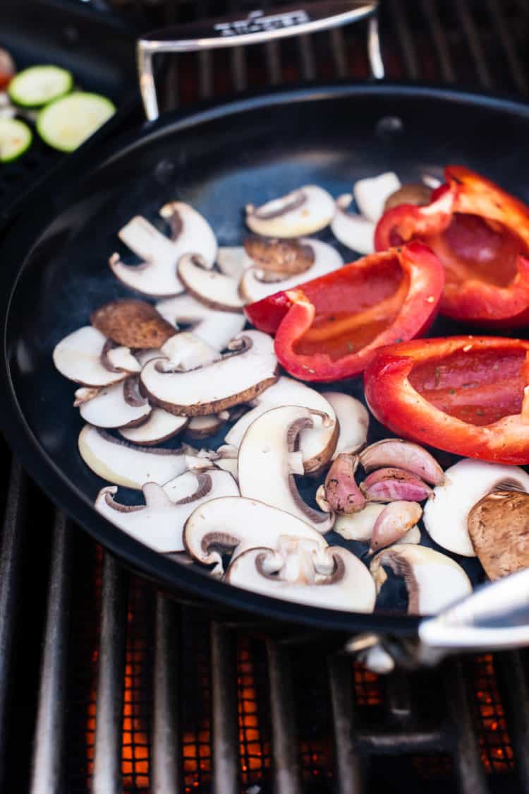 Grilling mushrooms and bell pepper on grill pan for Grilled Vegetable Pizza.